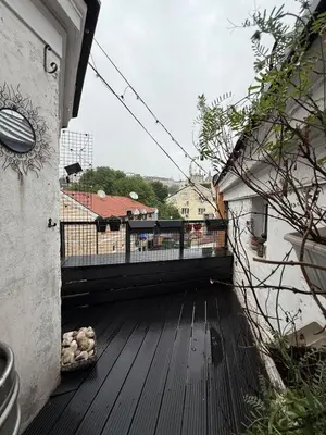 a wooden deck with a view of a house at Downtown Cozy Apartment in Belgrade