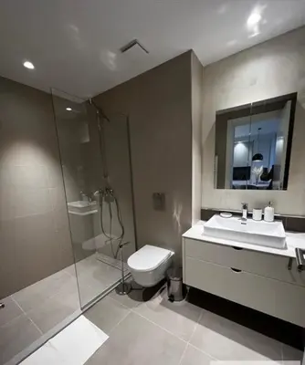 a bathroom with a shower and a toilet and a sink at BW Wilson in Belgrade