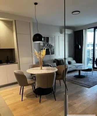 a living room with a table and chairs and a couch at BW Wilson in Belgrade