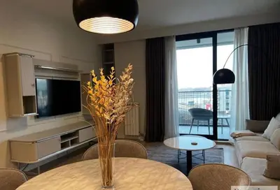 a living room with a vase of flowers on a table at BW Wilson in Belgrade
