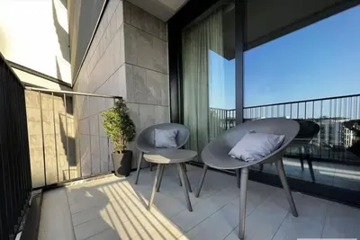two chairs with pillows sitting on a balcony at BW Wilson in Belgrade