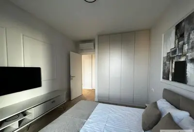 a living room with a flat screen tv on a wall at BW Wilson in Belgrade