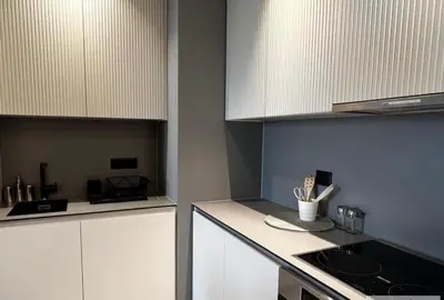a kitchen with white cabinets and a counter with utensils at BW Wilson in Belgrade