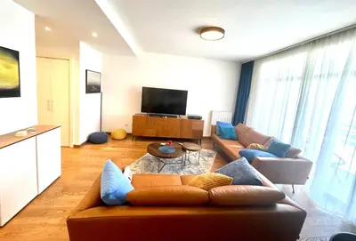a living room with a couch and a tv at Melania in Belgrade