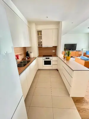 a kitchen with white cabinets and a sink at Melania in Belgrade
