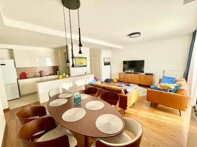 a kitchen and living room with a table and chairs at Melania in Belgrade
