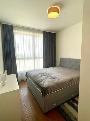 a bedroom with a bed and a large window at Melania in Belgrade