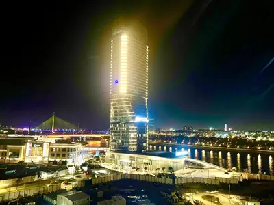 a tall building with lights on top of it at night at Melania in Belgrade