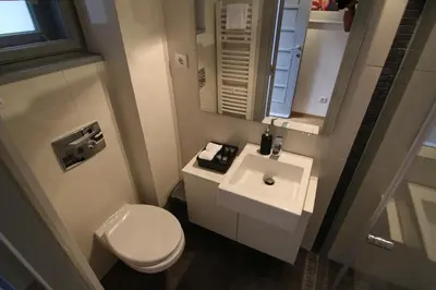 a small bathroom with a toilet and a sink at Apartments Centro in Belgrade