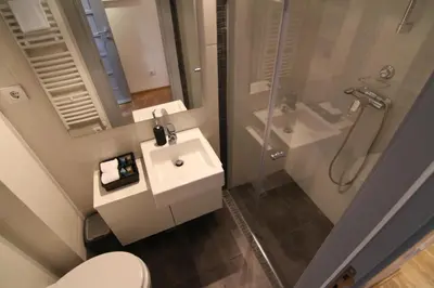a bathroom with a toilet and a sink and a shower at Apartments Centro in Belgrade