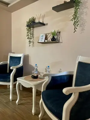 a waiting room with two chairs and a table at Jacuzzi Apartman PK Pančevo in Pančevo