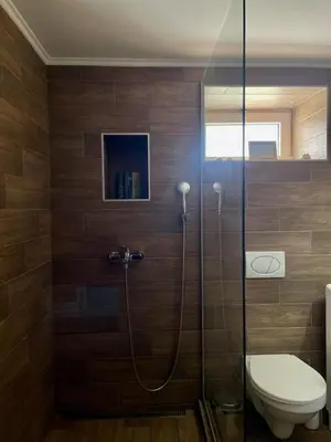 a bathroom with a toilet and a glass shower at Jacuzzi Apartman PK Pančevo in Pančevo