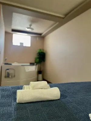 a stack of towels on a bed in a room at Jacuzzi Apartman PK Pančevo in Pančevo