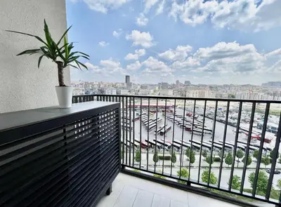 a balcony with a potted plant and a view of a harbor at BW Studio Metropolitan in Belgrade