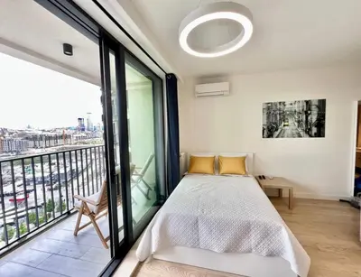 a bedroom with a bed and a large window at BW Studio Metropolitan in Belgrade