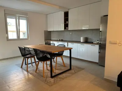 a kitchen with a wooden table and chairs at Zemun ES stan na dan in Belgrade