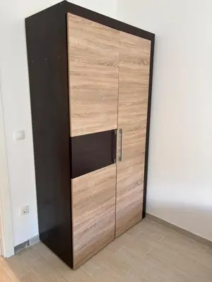 a closet with a wooden door in a room at Zemun ES stan na dan in Belgrade