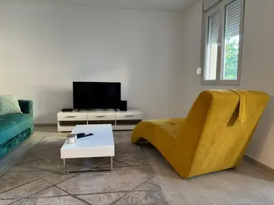 a living room with a couch and a tv at Zemun ES stan na dan in Belgrade