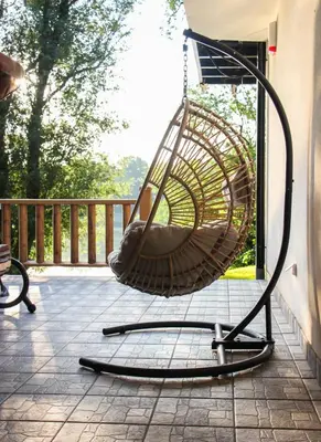 a swing on the porch of a house at Elowen in Novo Selo
