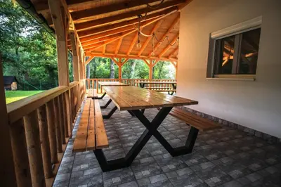 a picnic table on the porch of a house at Elowen in Novo Selo