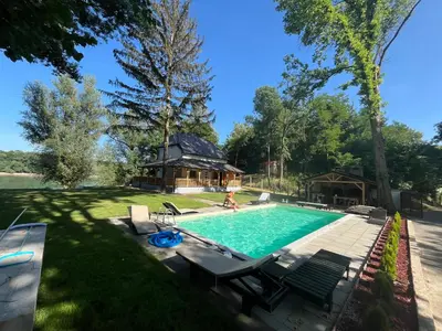 a woman is playing in a swimming pool in a yard at Elowen in Novo Selo