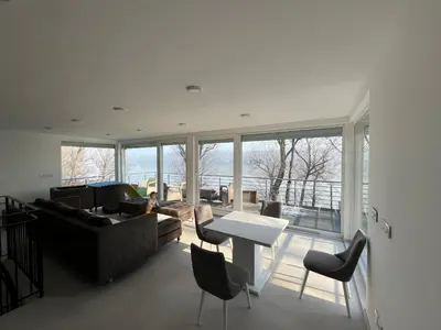 a living room with a couch and a table and chairs at Elowen in Novo Selo