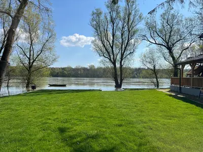a grassy area with a gazebo next to a lake at Elowen in Novo Selo