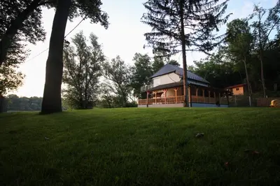 a large house in a field with a tree at Elowen in Novo Selo