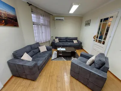 a living room with two couches and a table at Bukoleon Apartment in Belgrade