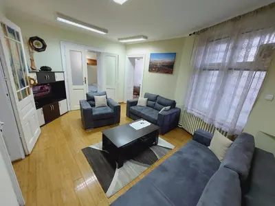 a living room with a couch and chairs and a table at Bukoleon Apartment in Belgrade