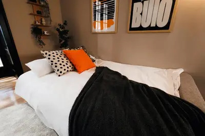 a white bed with pillows on it in a room at Soul House 110m2 with Balcony & Foosball Old Town in Belgrade