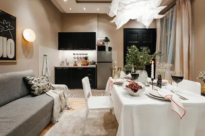 a living room with a table and a kitchen at Soul House 110m2 with Balcony & Foosball Old Town in Belgrade