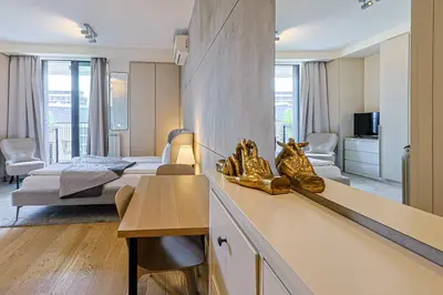 a hotel room with a bed and a living room at ZIGZAG Belgrade Waterfront Metropoliten in Belgrade