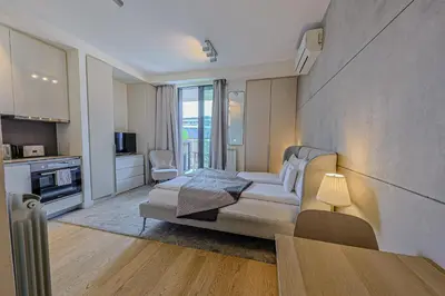 a living room with a couch and a table at ZIGZAG Belgrade Waterfront Metropoliten in Belgrade