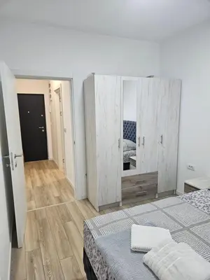 a white room with a bed and a mirror at Miss LuX in Mladenovac