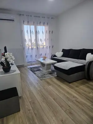 a living room with a couch and a table at Miss LuX in Mladenovac