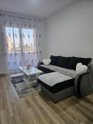 a living room with a couch and a table at Miss LuX in Mladenovac