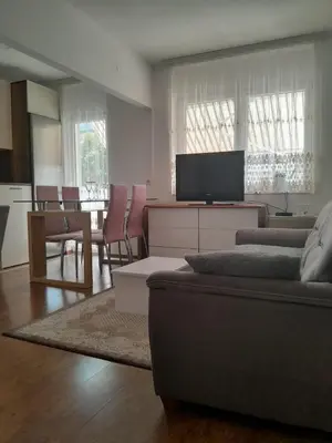 a living room with a couch and a dining room at Batajnica centar in Belgrade