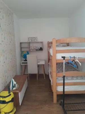 a bedroom with two bunk beds and a desk at Batajnica centar in Belgrade