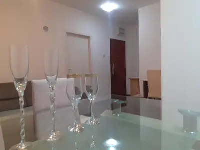 three wine glasses sitting on top of a glass table at Batajnica centar in Belgrade