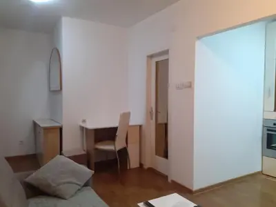 a living room with a desk and a table with a chair at Batajnica centar in Belgrade