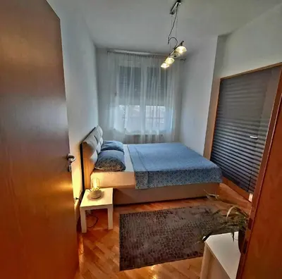 a bedroom with a bed and a window at BelMont Vračar in Belgrade