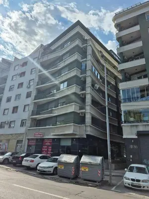 a tall building with cars parked in front of it at BelMont Vračar in Belgrade