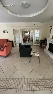 a living room with a couch and a table at Vila Monika in Belgrade
