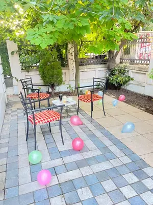 a patio with two chairs and a table with ping balls at Vila Monika in Belgrade