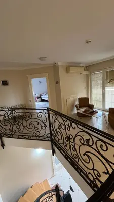 a staircase in a living room with a living room at Vila Monika in Belgrade