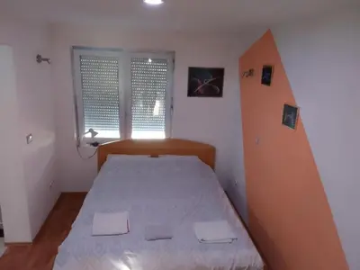 a small bedroom with a bed and a window at Zemun in Belgrade