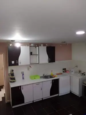 a kitchen with white cabinets and a sink at Zemun in Belgrade