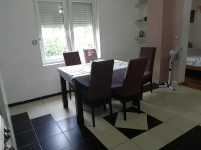 a dining room table and chairs in a room at Zemun in Belgrade