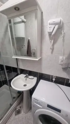 a bathroom with a sink and a toilet and a mirror at Stan na dan Beoshoping in Belgrade